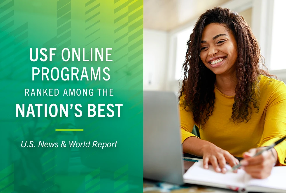 A woman smiles while writing in a notebook